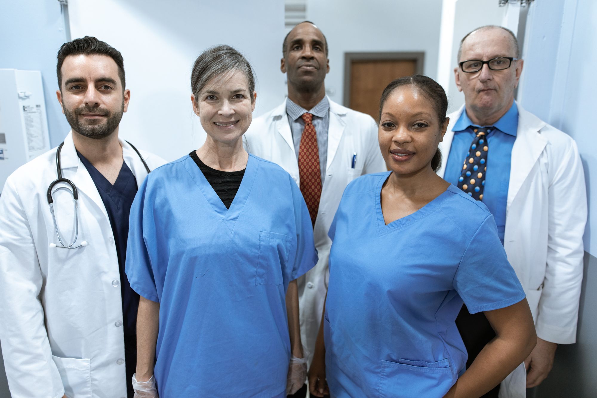 Pflegeteam aus Pflegekräften und Ärzten im Klinikflur